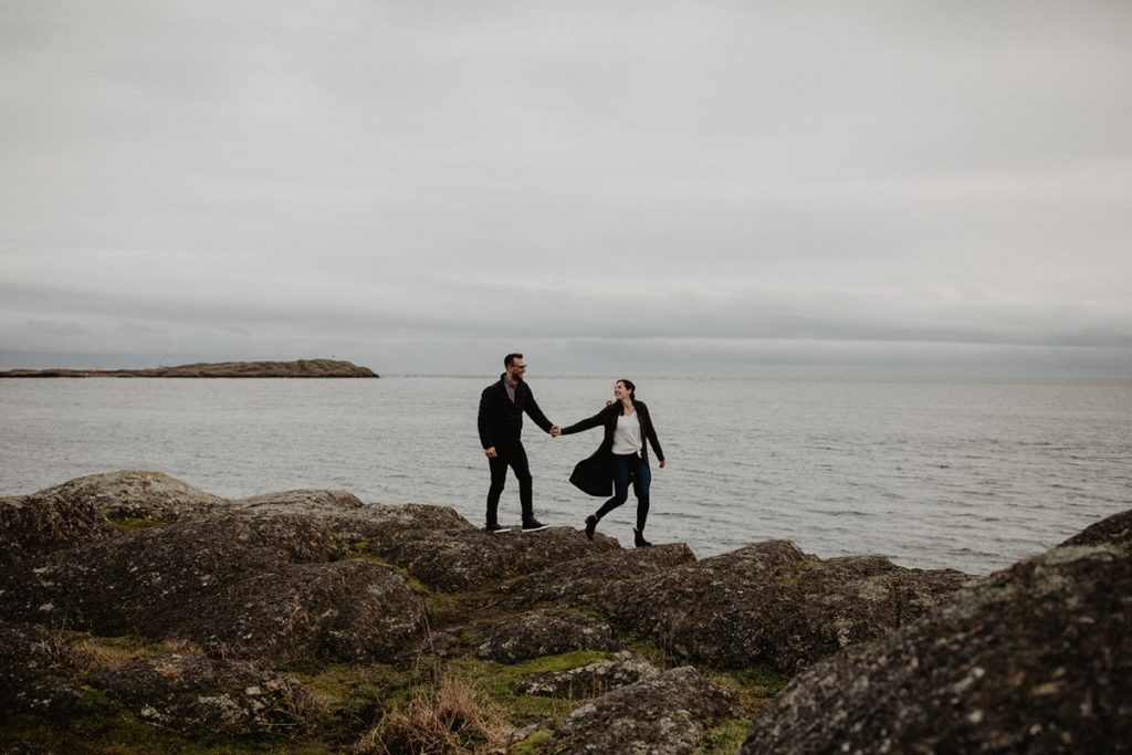 couple exploring the moody coastline of Vancouver Island in the spring