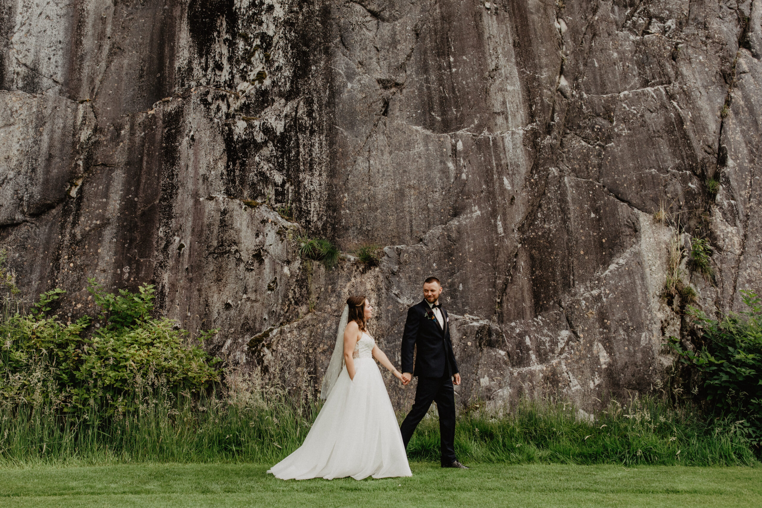 bride and groom in front of BC mountain